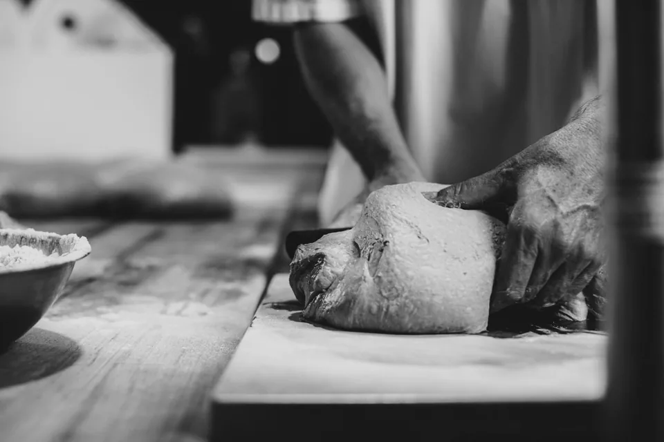 A Sonoma baker working bread dough, from Sonoma’s official Glebe page.