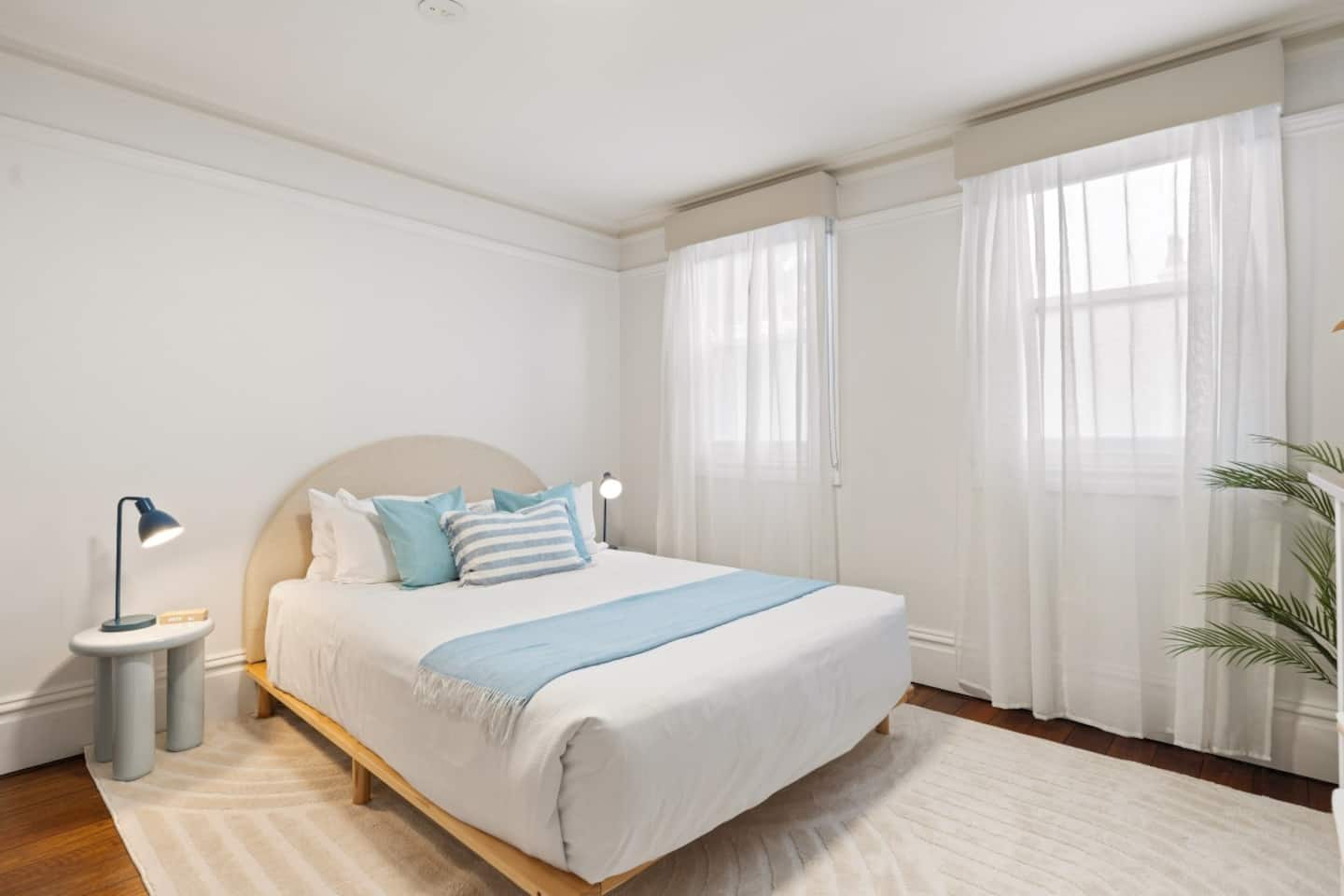 The Azure Retreat bedroom with blue accents and natural light