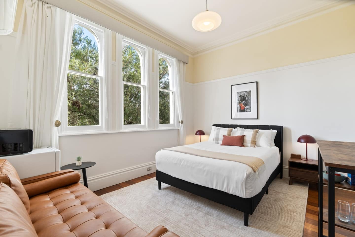 The Jazz Room with rich timber floors, bed, sofa and jazz artwork