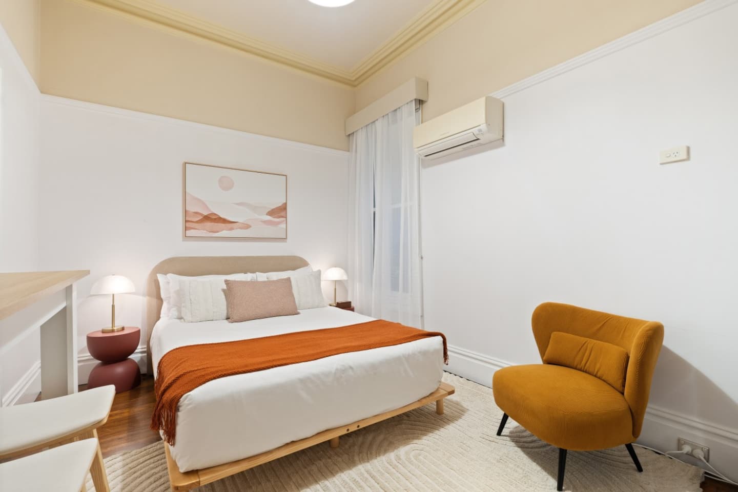 The Terracotta Room with warm terracotta bedding and artwork